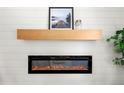 Bright living room features a modern electric fireplace and floating mantel on shiplap wall at 2244 Alpha Dr, Decatur, GA 30032