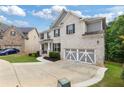 Charming two-story home with a brick facade, manicured lawn, and a two-car garage at 2307 Loughridge Dr, Buford, GA 30519