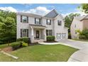 Charming two-story home with a brick facade, manicured lawn, and a two-car garage at 2307 Loughridge Dr, Buford, GA 30519