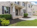 Charming two-story home with a brick facade, manicured lawn, and a two-car garage at 2307 Loughridge Dr, Buford, GA 30519