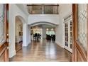 Inviting foyer with hardwood floors, arched doorways, and a view of the open-concept living spaces at 2910 Creek Tree Ln, Cumming, GA 30041