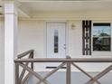 Close-up of the front entry door with sidelight window and a stylish decorative front porch railing at 8535 Hiram Acworth Hwy, Dallas, GA 30157