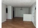 Open-concept living space with wood-look floors, neutral walls, and a view into the kitchen at 14104 Fairington Circle Ridge, Stonecrest, GA 30038
