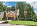Attractive home with lush landscaping, a brick driveway, and a traditional architectural style at 3405 Glenrose Trail Trl, Atlanta, GA 30341