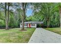 Charming renovated home with an orange front door, cedar shutters, and a long driveway at 737 Bolton Nw Rd, Atlanta, GA 30331