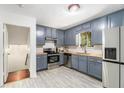 Stylish kitchen with stainless steel appliances and painted cabinets with butcher block countertops at 240 Wellington Dr, Mcdonough, GA 30252