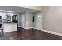 Spacious living area features sleek hardwood floors and ample natural light, seamlessly flowing into the modern kitchen at 2443 Abner Nw Pl, Atlanta, GA 30318