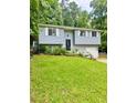 Charming home featuring a well-manicured lawn, light blue siding, and white garage door at 3544 Citrus Dr, Duluth, GA 30096