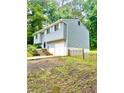 Split-level home with light blue siding, white trim, and a one-car garage at 3544 Citrus Dr, Duluth, GA 30096