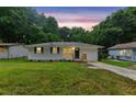Charming single-story home with a well-maintained lawn and inviting curb appeal at twilight at 2049 Phillips Dr, Atlanta, GA 30315