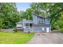 Charming two-story home with an attached garage and a well-maintained front yard at 3328 Hidden Bluff Trl, Snellville, GA 30039