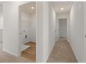 Hallway with laundry closet featuring wood flooring at 1236 Arnhem Dr, Hampton, GA 30228