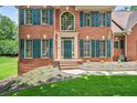 Close-up of the brick facade with large windows and decorative shutters, enhancing the home's curb appeal at 2020 Ridge Gate Drive Dr, Cumming, GA 30041