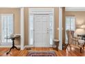 Inviting foyer with hardwood floors, a decorative rug, and ample natural light from the front door at 2020 Ridge Gate Drive Dr, Cumming, GA 30041