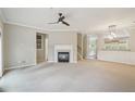 Comfortable living room with a fireplace, neutral walls, carpet and recessed lighting at 11302 Musette Cir, Alpharetta, GA 30009