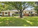 Charming home featuring a well-manicured lawn and a classic brick and white exterior at 2785 Toney Dr, Decatur, GA 30032