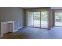Bright living room featuring wood floors and sliding glass doors leading to the outdoor patio at 3575 Oakvale Rd # 305, Decatur, GA 30034