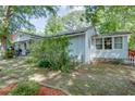 Side view of home showcasing siding, a small porch, and landscaping at 4236 Florida Nw Ave, Atlanta, GA 30360