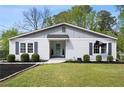 Inviting home featuring a well-kept lawn, attractive landscaping, and a bright blue front door at 1251 Pierce Ave, Smyrna, GA 30080