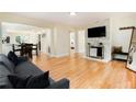 Bright living room featuring hardwood floors and a stylish stone accent wall with mounted TV at 361 Adelle Se St, Atlanta, GA 30315