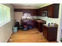 A kitchen featuring wood cabinets, granite countertops, and a window overlooking the yard at 1487 Colony East Cir, Stone Mountain, GA 30083