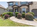 Charming two-story brick home with a well-manicured lawn and walkway to front door at 2183 Trinity Grove Ct, Dacula, GA 30019