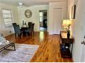 Open-concept living area featuring dining space, hardwood floors, and natural light at 1403 Dennis Dr, Decatur, GA 30032