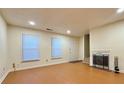 Spacious living area with wood-look floors, fireplace, and multiple windows for natural light at 3533 Mulberry Way, Duluth, GA 30096