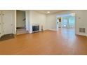 Bright living room featuring wood-look flooring, a fireplace, and access to other rooms at 3533 Mulberry Way, Duluth, GA 30096