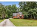 Charming two-story home surrounded by lush greenery, offering privacy and curb appeal at 4137 Donna Ct, Ellenwood, GA 30294