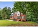 Attractive brick home featuring a well-maintained lawn, classic architecture and inviting entryway at 4137 Donna Ct, Ellenwood, GA 30294
