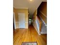 Inviting entryway with gleaming hardwood floors and staircase access to upper levels at 1435 Great Oaks Dr, Lawrenceville, GA 30045