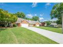 Long driveway to attractive brick homes with well-manicured lawns on a sunny day at 535 Brickleberry Ln, Roswell, GA 30075