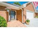 Inviting front entrance with a hanging flower basket and a well-maintained brick facade at 535 Brickleberry Ln, Roswell, GA 30075