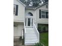 Close-up showcasing a home's front door, accessed by white stairs, with a decorative arched window above at 95 Heartwood Xing, Dallas, GA 30157