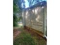 Exterior view of home showing siding detail with view of side yard and lawn at 95 Heartwood Xing, Dallas, GA 30157