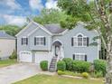 Inviting two-story home with manicured landscaping, two-car garage and traditional architectural details at 1735 Silver Way, Lithia Springs, GA 30122