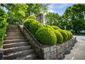 Stone steps leading to an apartment building entrance surrounded by manicured bushes at 790 North Ne Ave # 209, Atlanta, GA 30306