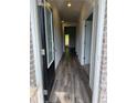 Bright foyer showcasing beautiful hardwood floors with views to a window at the end of the hall at 1601 Dosk Ave, Lawrenceville, GA 30044