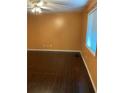 Bedroom with hardwood flooring, orange colored walls, and a window allowing for natural light at 1867 Myrtle Dr # 5, Atlanta, GA 30311