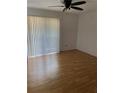 Bedroom features hardwood flooring, a modern ceiling fan, and sliding glass doors at 1867 Myrtle Dr # 5, Atlanta, GA 30311