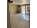 Open concept living room with tile floor, sliding glass doors, and ceiling fan at 1867 Myrtle Dr # 5, Atlanta, GA 30311