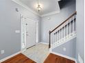Bright foyer featuring hardwood floors, a white front door, and stairs at 3737 Town Square Nw Cir # 6, Kennesaw, GA 30144