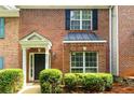 Two-story brick townhome with black accents and mature landscaping at 3737 Town Square Nw Cir # 6, Kennesaw, GA 30144