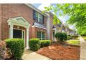 Brick townhome featuring a well-manicured lawn and covered front entrances at 3737 Town Square Nw Cir # 6, Kennesaw, GA 30144