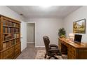 Cozy office space with a wooden desk, bookshelf, and comfortable leather chair at 2047 Cliffton Ter, Snellville, GA 30039