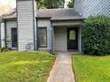 Charming home featuring a quaint front entry with a dark front door and well-maintained lawn at 267 Toweridge Sw Dr, Marietta, GA 30064