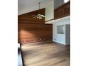 Spacious living room with hardwood floors, a wooden accent wall, and a high ceiling at 267 Toweridge Sw Dr, Marietta, GA 30064