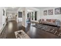 Open-concept living room featuring hardwood floors, modern furniture, and seamless flow to kitchen at 3711 Wartrace Dr, Atlanta, GA 30331