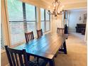 Light-filled dining room featuring a dark wood table and views to a living room and the outdoors at 1612 Huntingdon, Atlanta, GA 30350